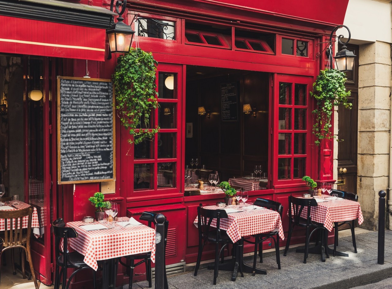 Cozy street with tables of cafe in Paris, France