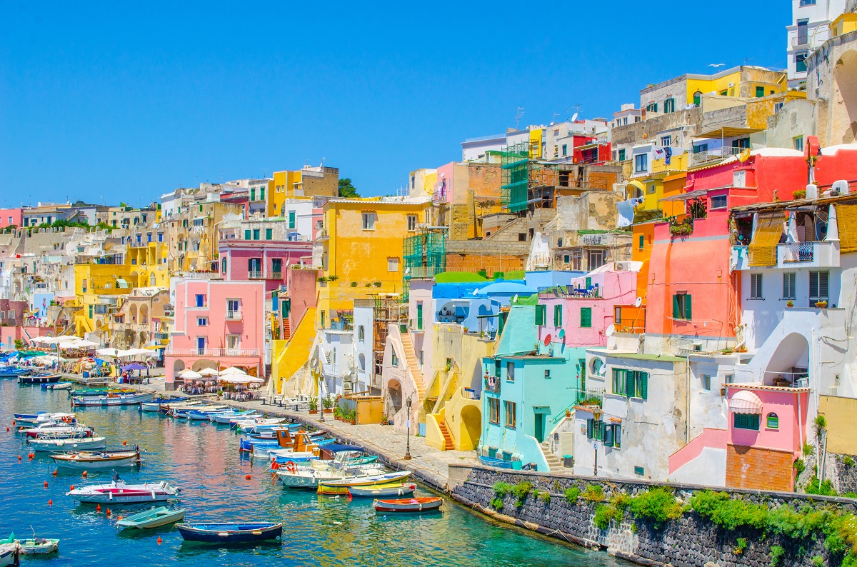 italian island procida is famous for its colorful marina, tiny narrow streets and many beaches which all together attract every year crowds of tourists coming from naples - napoli.