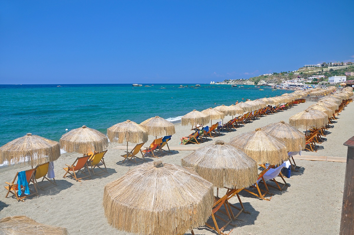 The picturesque beach on the Italian island of Ischia - the blue sea and white sand