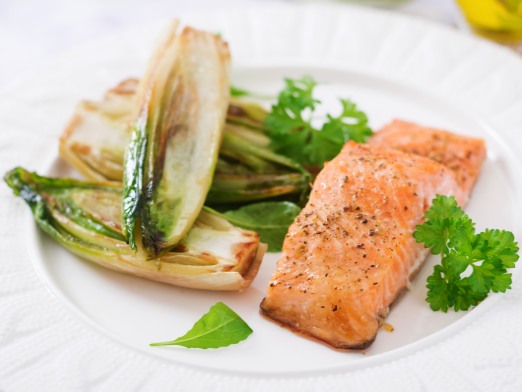 Baked salmon with Italian herbs and garnished with chicory
